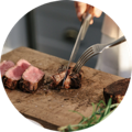 Slicing into a perfectly cooked and seared medium rare steak