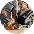 Father and daughter preparing dinner together with fresh ingredients