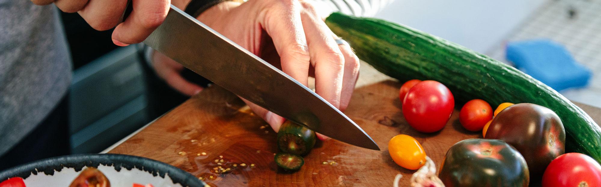 Dad and daughter preparing vegetables on a cutting board