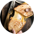 Gooey grilled cheese sandwich being pulled apart, ready to serve